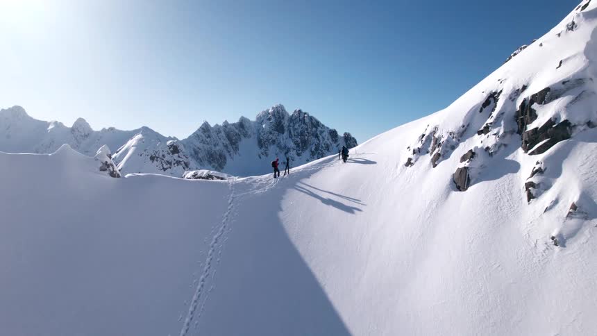 Skiers are standing on the mountain top