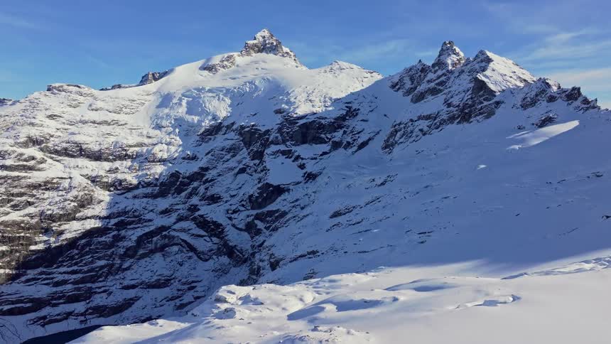 Snow covered mountain under a sunny sky
