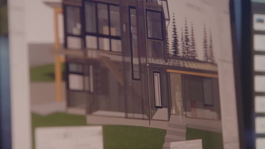 This video provides a closeup slightly angled view of a digital architectural rendering displayed on a computer screen showing a modern twostory building design with large windows and a distinct wooden facade the detailed rendering appears to be part