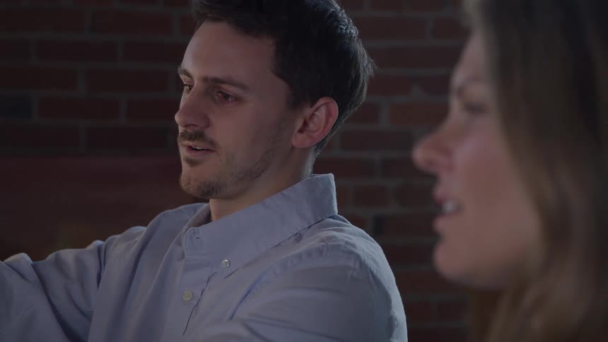 Two workers have a discussion in the office