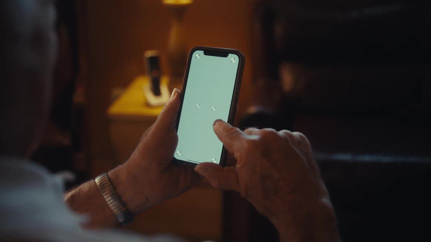 A man taps at a phone screen
