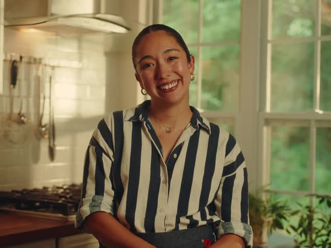 Woman in kitchen with happy expression