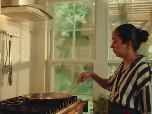 Woman cooking in a frying pan