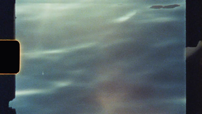 Close up of the surface of a flowing body of water reflecting sunlight during daytime