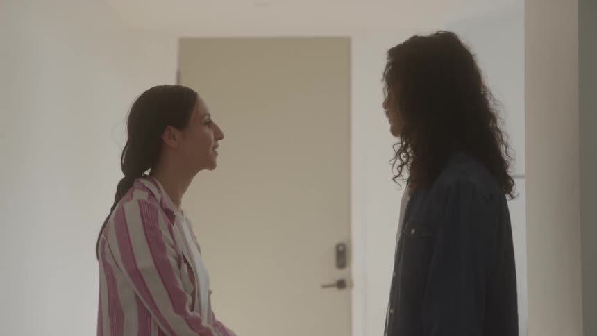 Two women having a conversation indoors