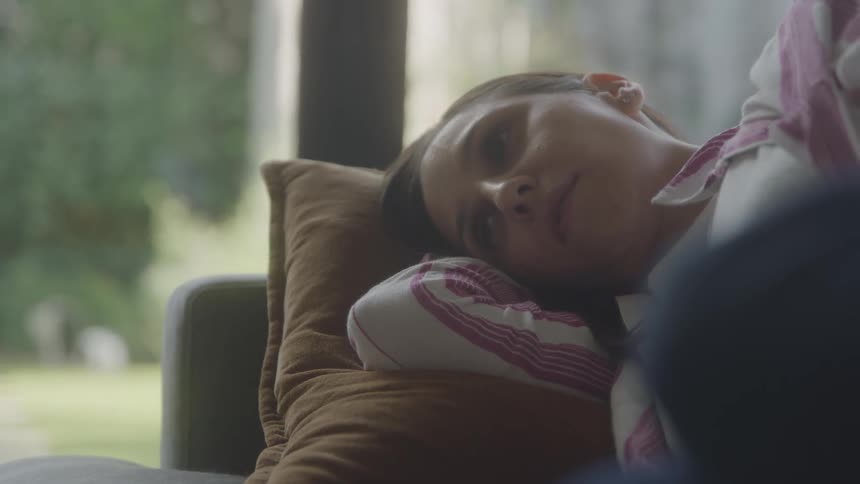 Woman lying on the sofa in the living room