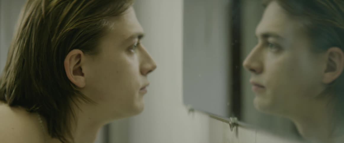 A man looks close in the mirror