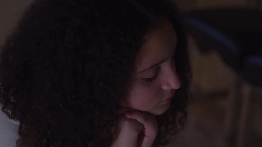 Curlyhaired woman with a dejected expression