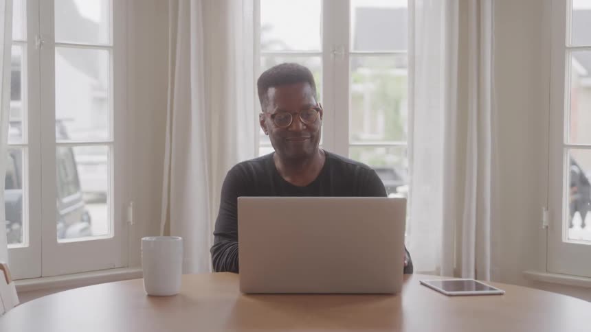 Man sitting working in front of a laptop