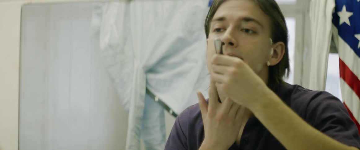 A man is shaving his face