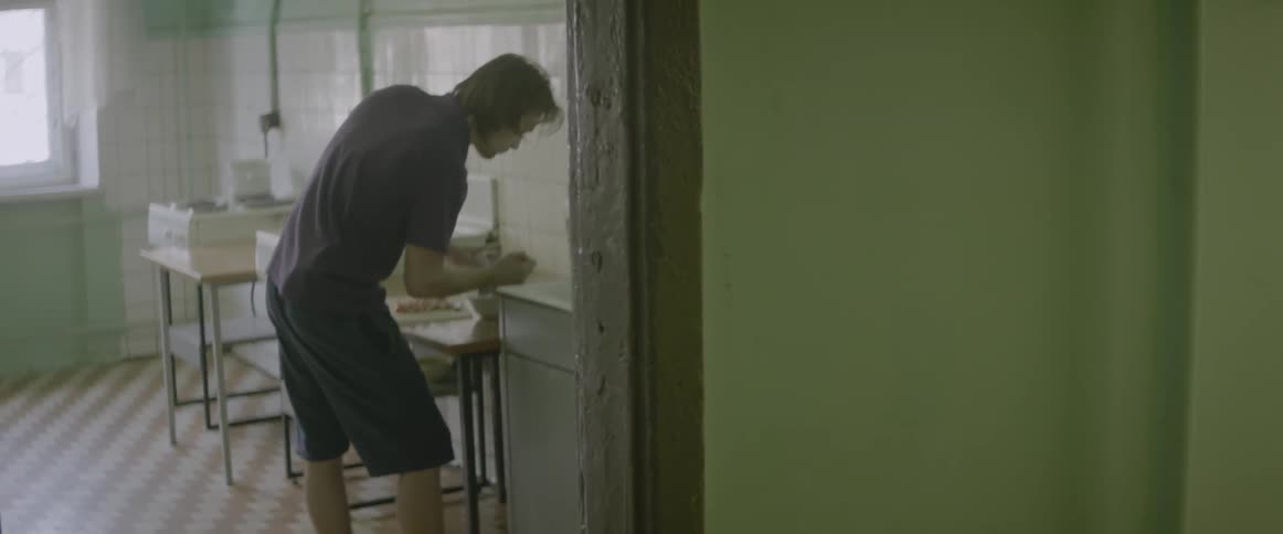 A man is preparing food in a kitchen