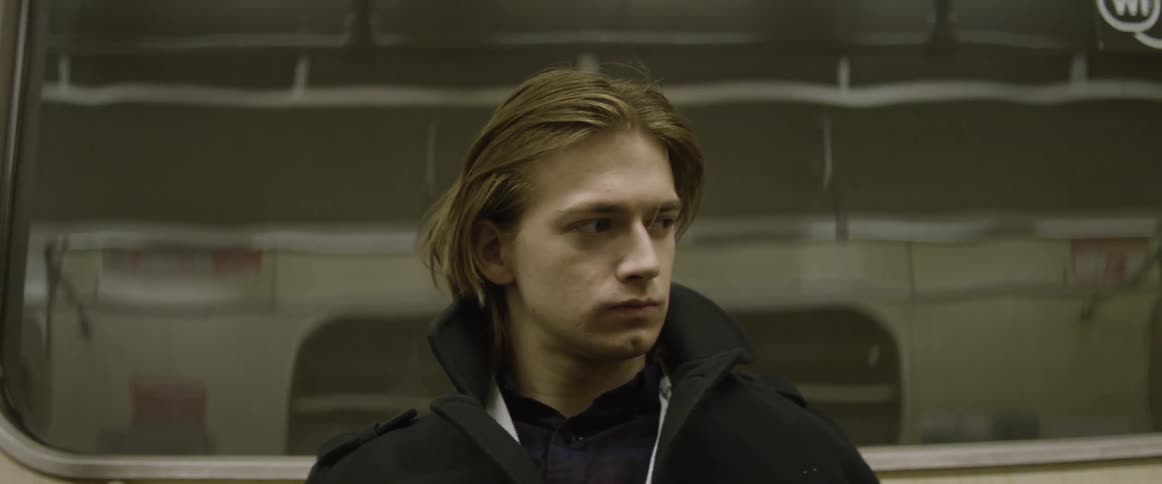 A man is sitting in a moving train