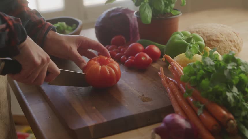 A tomato being sliced