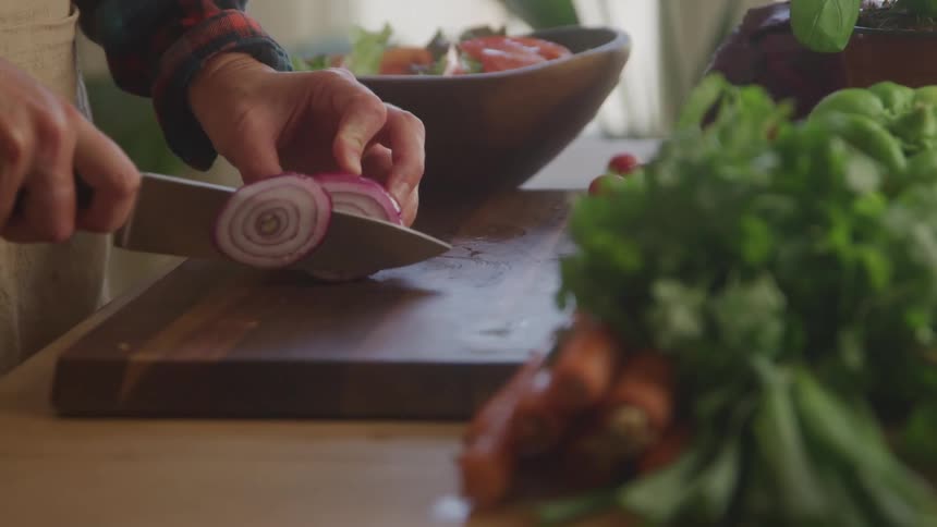 A person slicing an onion