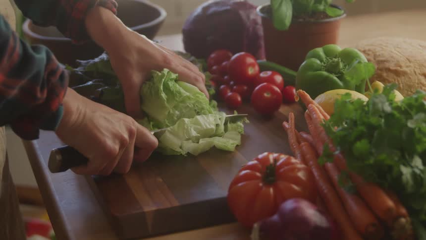 The cook is cutting vegetables