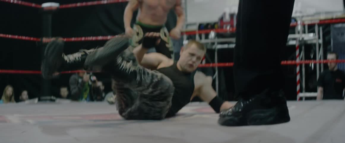 Two men inside a ring wrestling each other