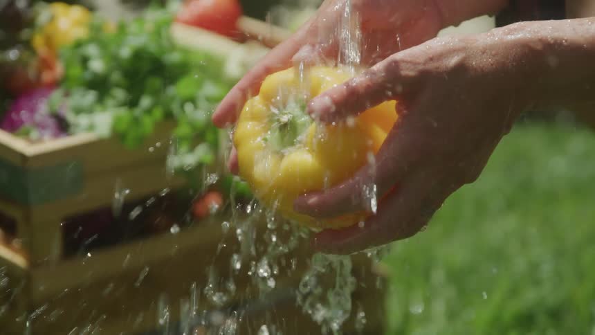 A person washes a pepper