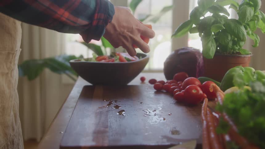 A person makes a salad