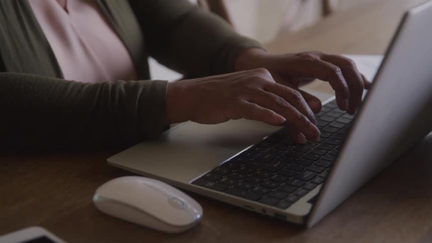 Someone types on a laptop