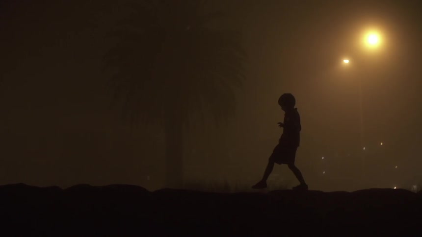 Child running through a field at night