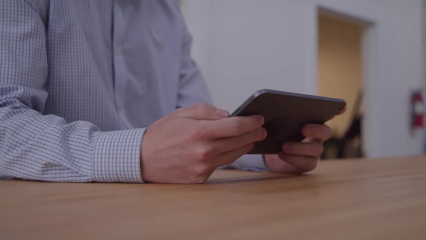 Pair of hands of a person holding a tablet
