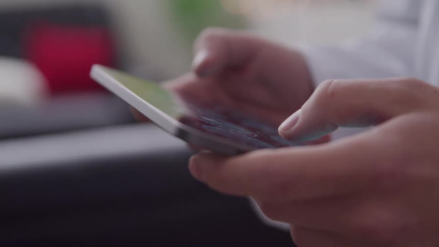 Hands holding and interacting with a tablet