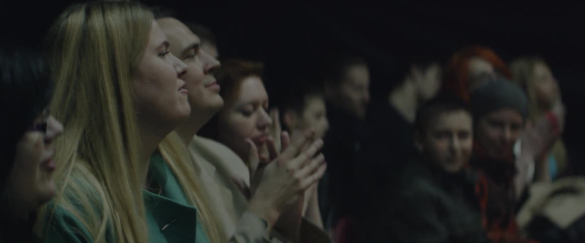 An audience cheers and claps