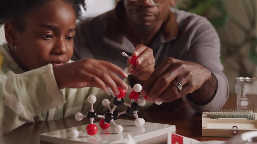 Father and son are building a model together