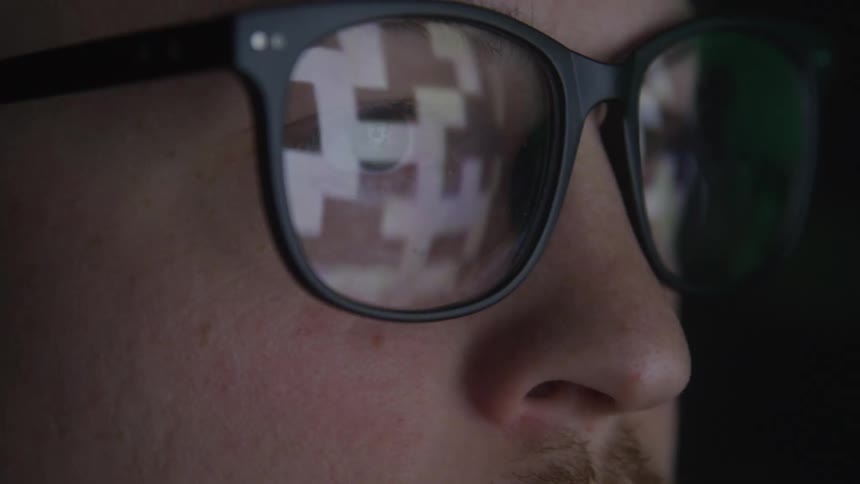 Abstract reflection in a mans glasses