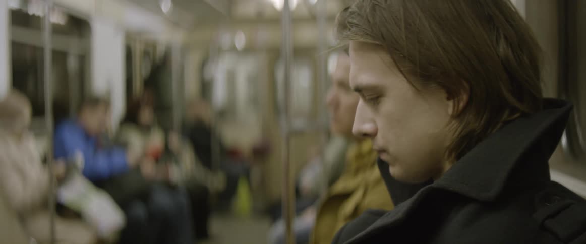 A man rides a subway train