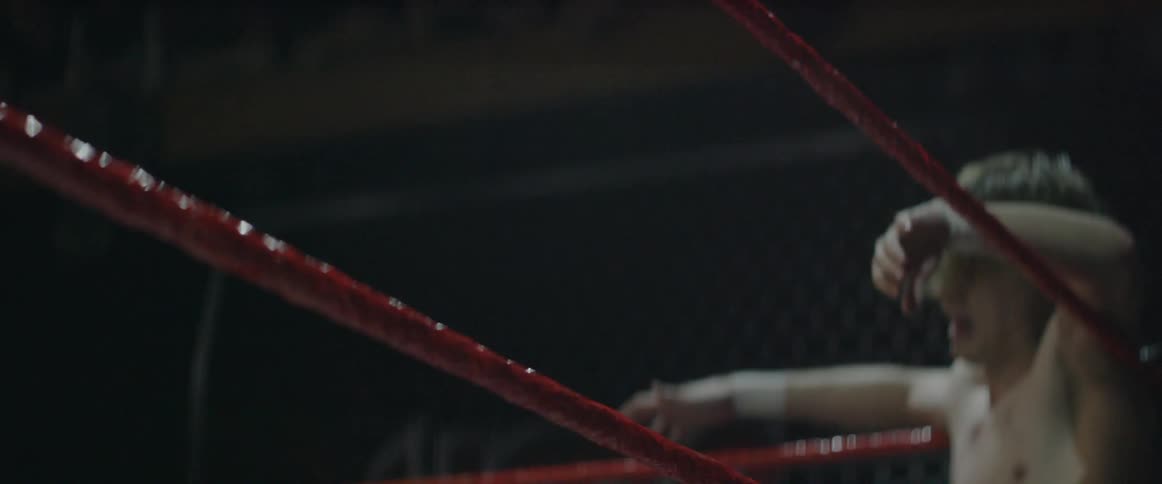 Two men fighting in a ring