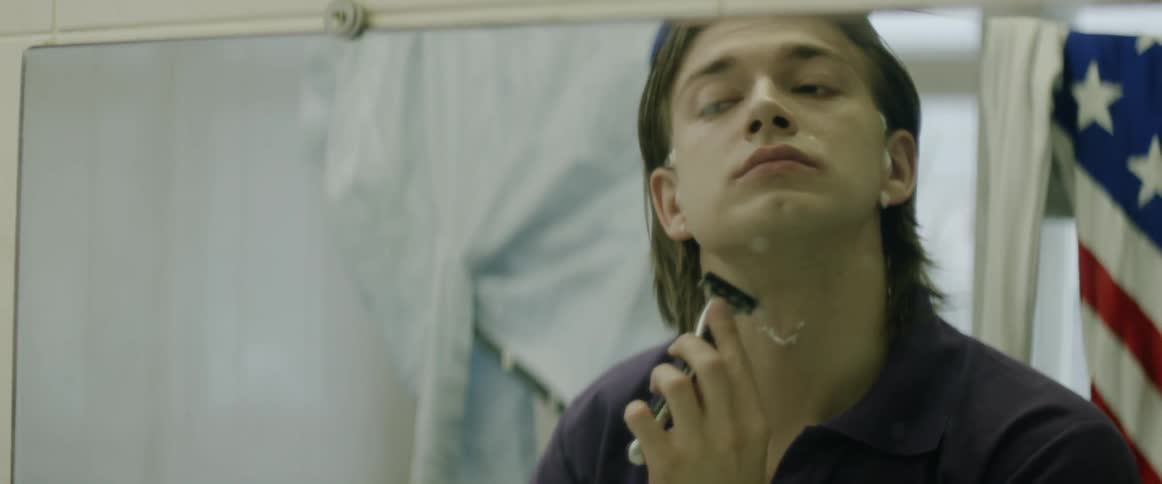A man shaves his neck
