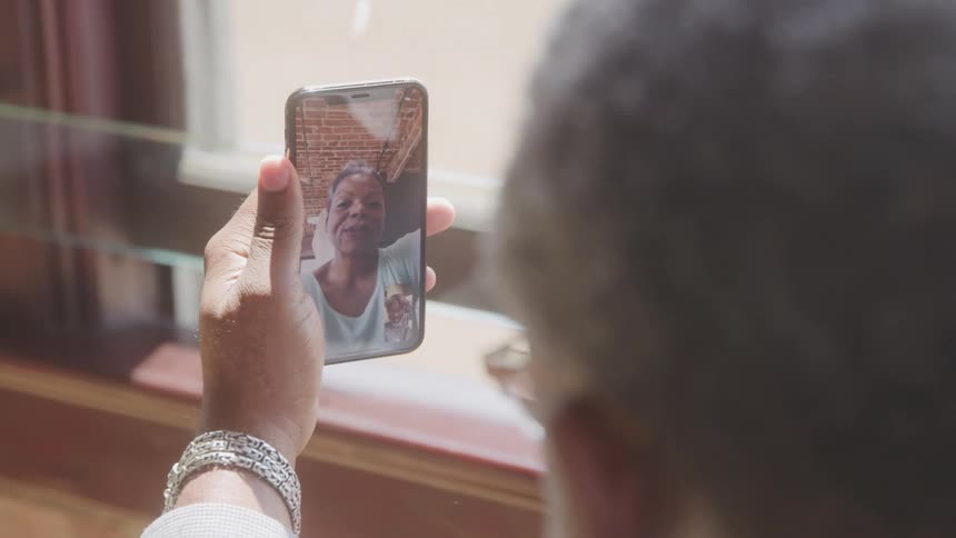 A man talking on the smartphone with his wife