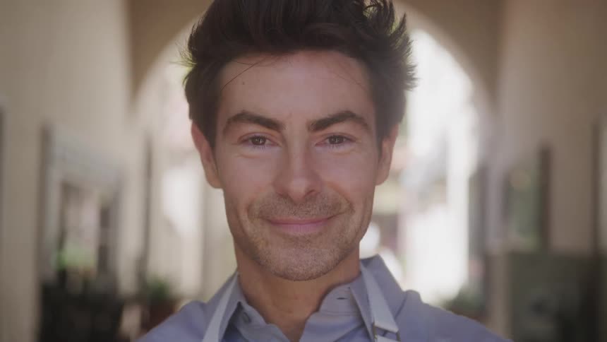 A man smiles at the camera