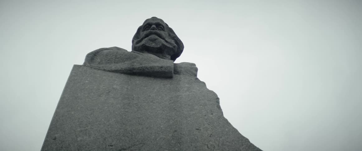 A stone statue towers overhead