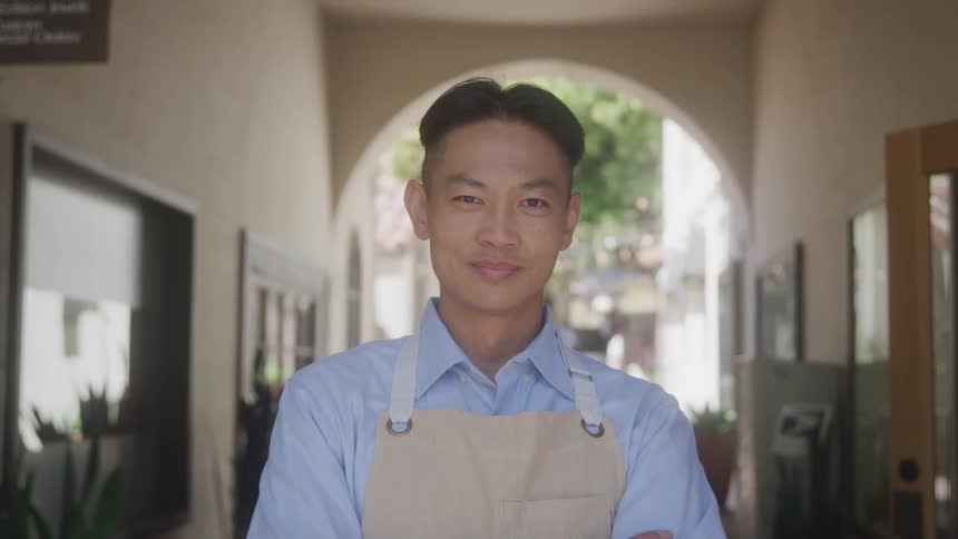 Man with happy expression wearing chef apron