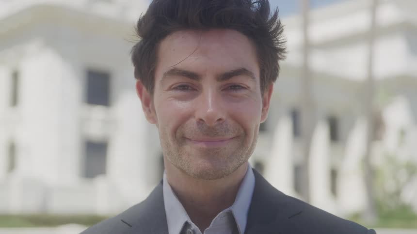 A man smiles at the camera