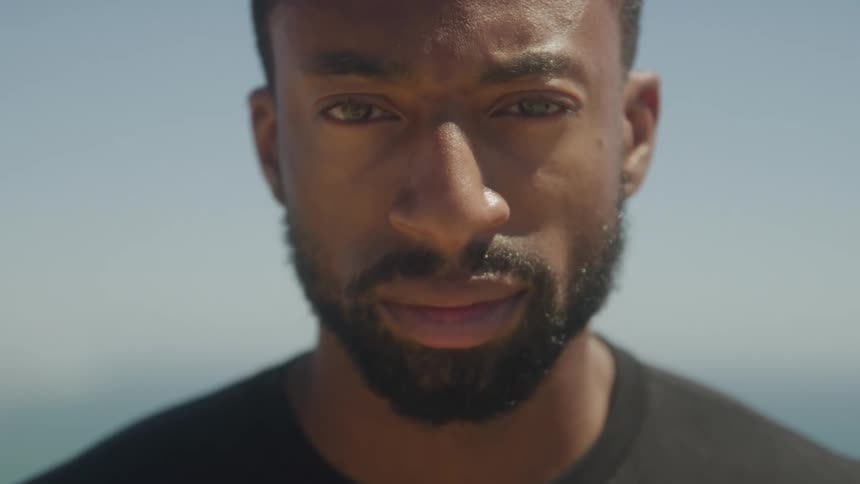 Bearded man outdoors with neutral expression
