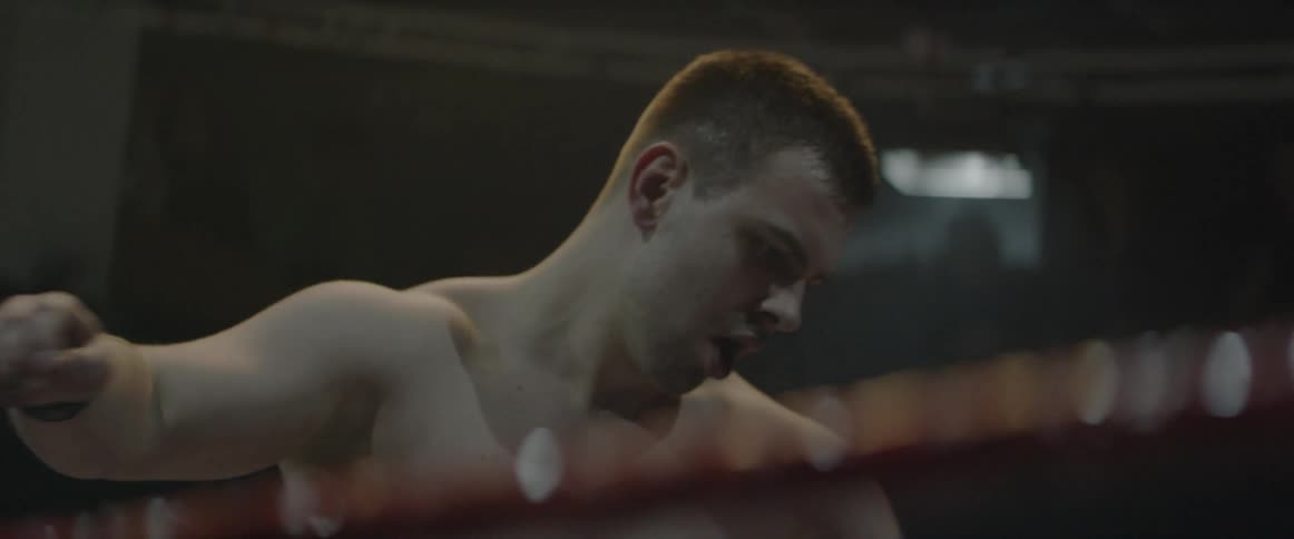 Two men wrestle in a ring
