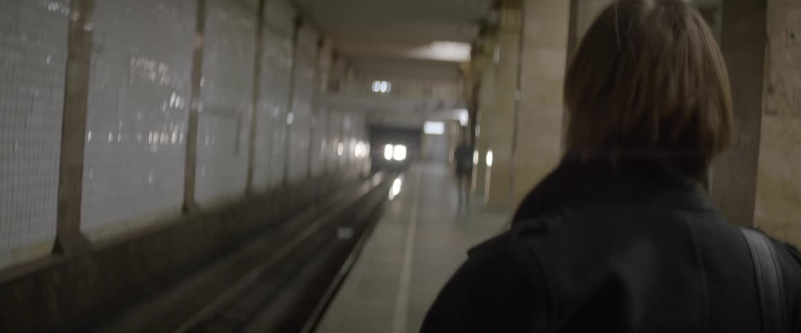 People wait for a subway train to arrive