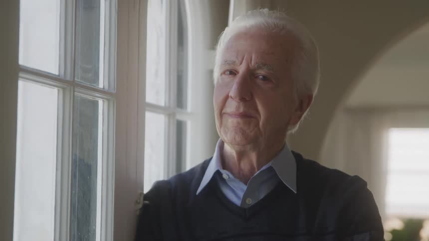 The man is smiling at home