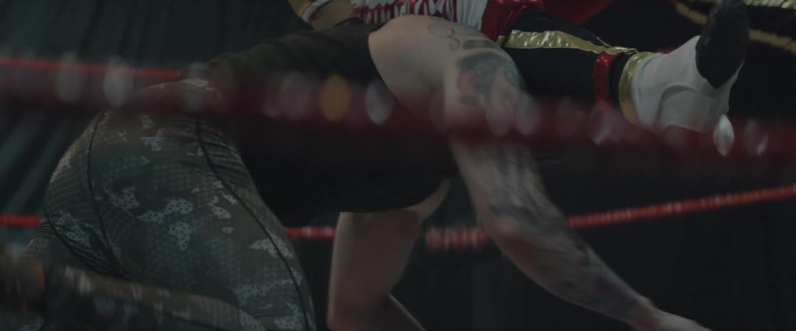Two men wrestle in a ring