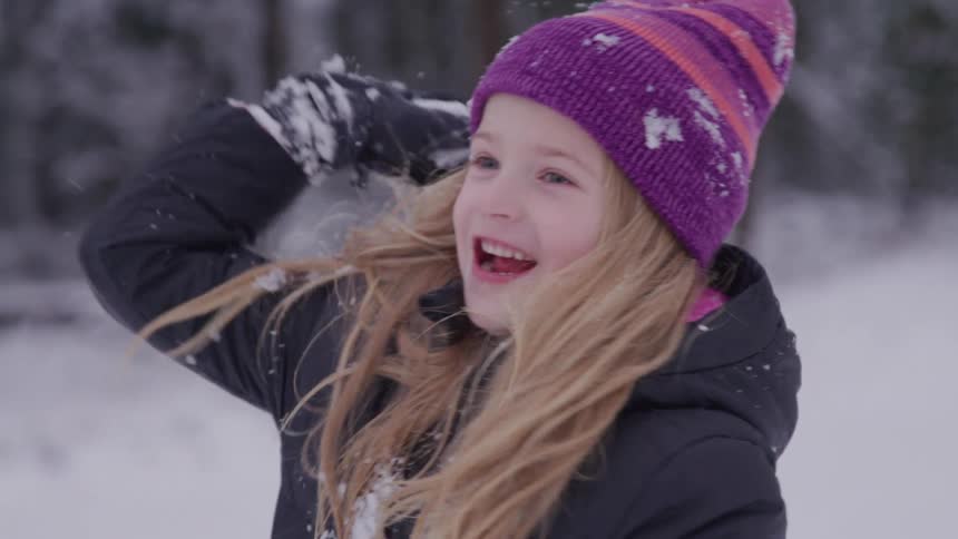A girl throws a snowball