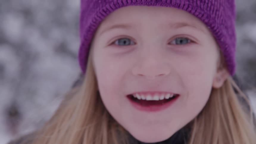 A child comes closer to the camera and smiles