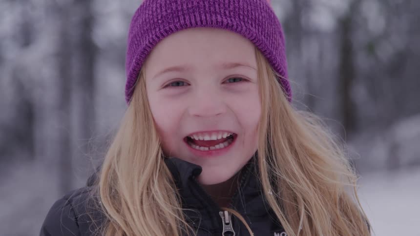 Portrait of a little girl smiling happily outdoors