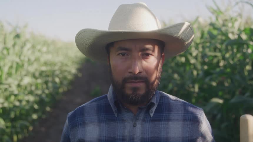 A farmer looks at the camera