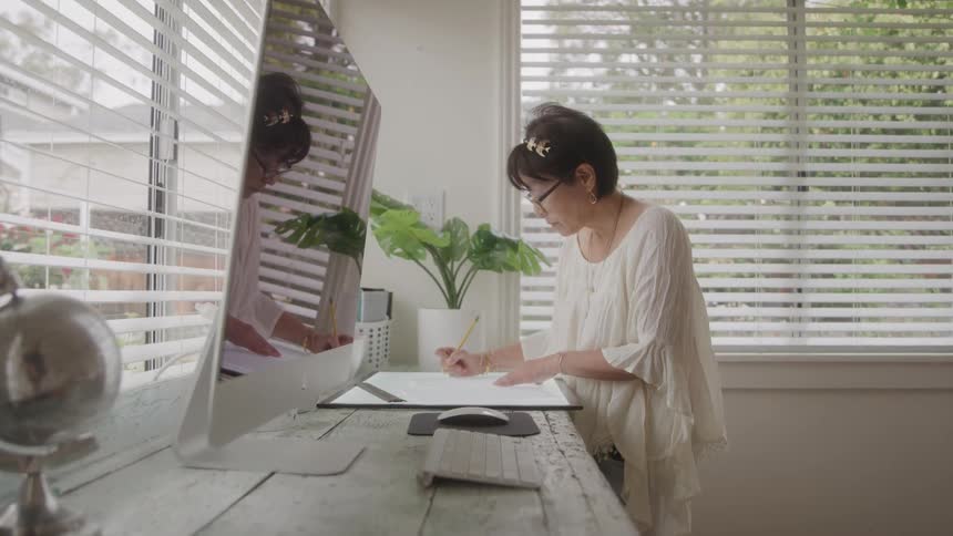 Woman with a pencil and drawing a project on a digital screen
