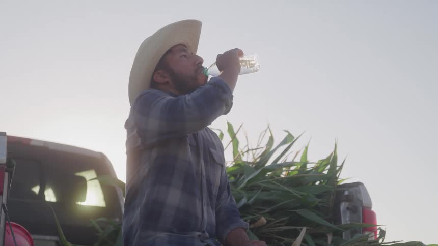 Man in hat drinking water