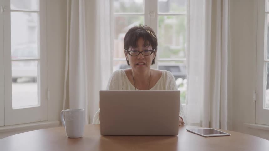 A woman looks at her computer