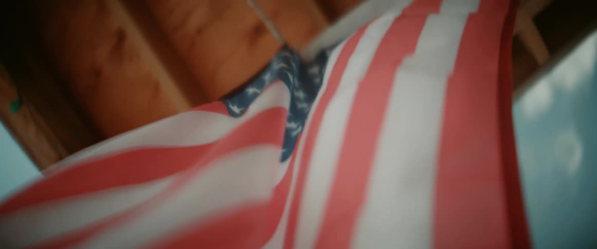 The hanging american flag hangs and blows in he wind